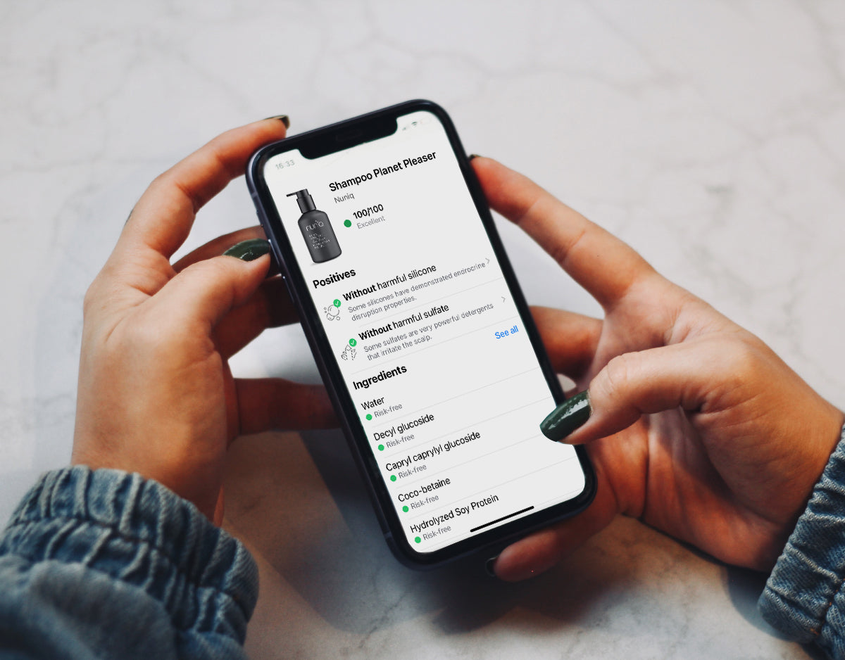 Close-up of a smartphone scanning a beauty product ingredient list, illustrating transparency in clean beauty thanks to Yuka.
