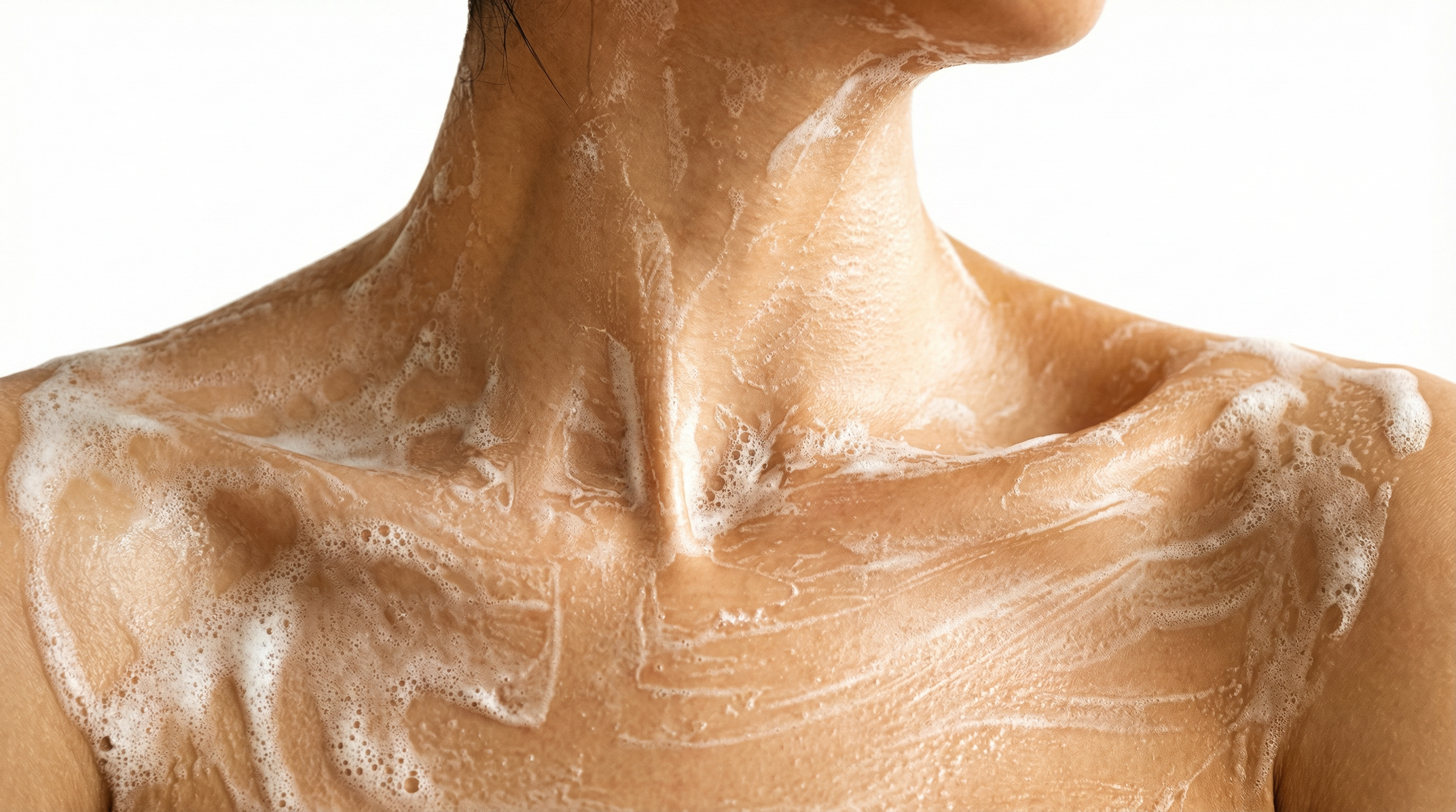 Woman cleansing her face with a gentle cleanser to remove impurities and maintain healthy skin.