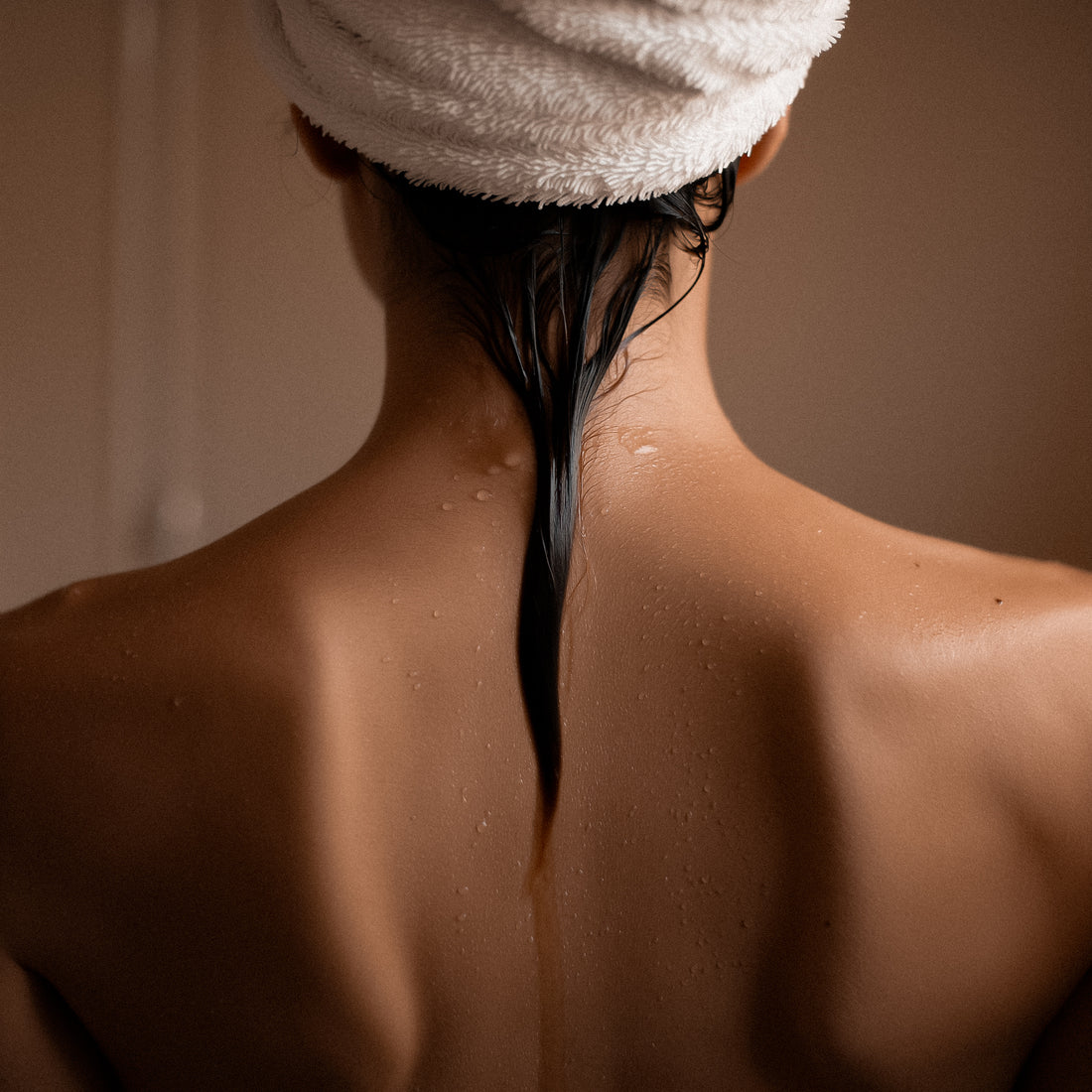 woman with wet har and head towel