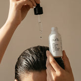 woman apply hair booster