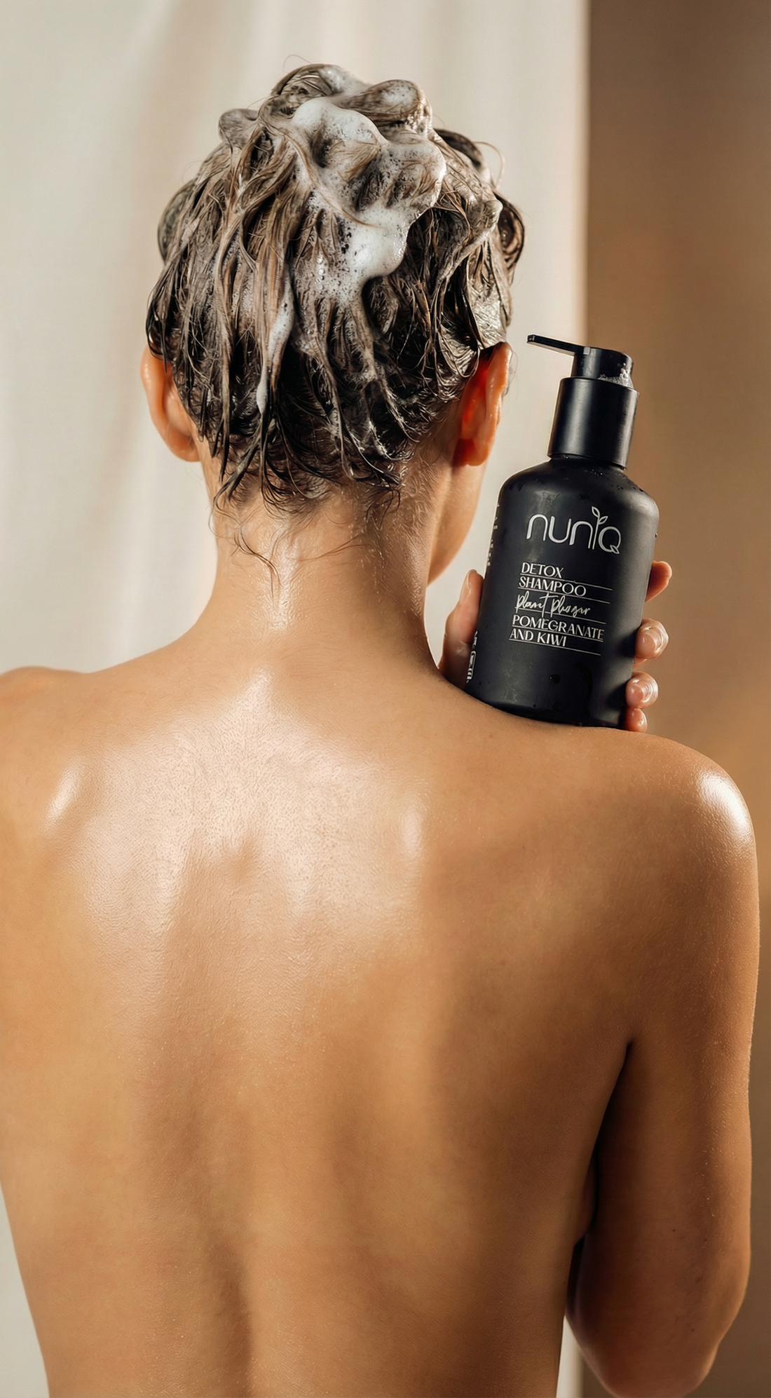 woman holding the shampoo bottle