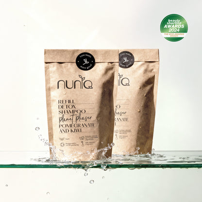 Nuniq refill detox shampoo packaging with water splash on a white background
